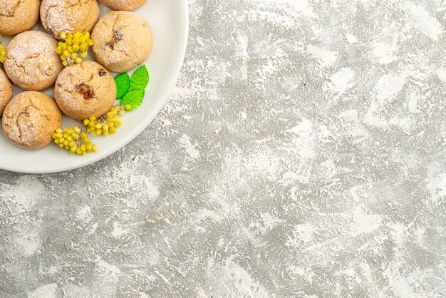 Top view delicious sugar cookies inside plate on a white background sugar cookie sweet biscuit cake tea