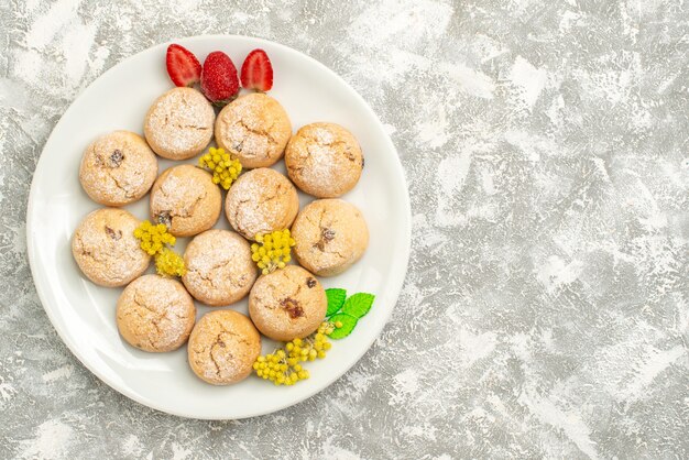 Top view delicious sugar cookies inside plate on a white background sugar cookie sweet biscuit tea cake