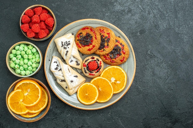 어두운 표면 설탕 비스킷 달콤한 케이크 쿠키 차에 파이와 오렌지 슬라이스 상위 뷰 맛있는 설탕 쿠키