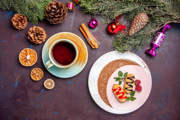 Top view delicious sweet biscuits with cup of tea on dark background cookie sweet biscuit sugar color cake