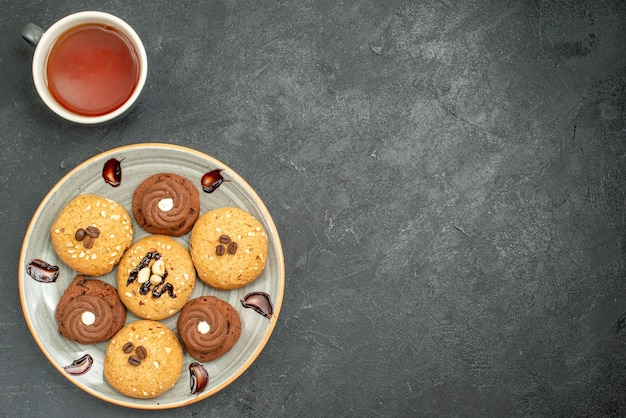 Top view delicious sweet cookies yummy sweets for tea on grey space