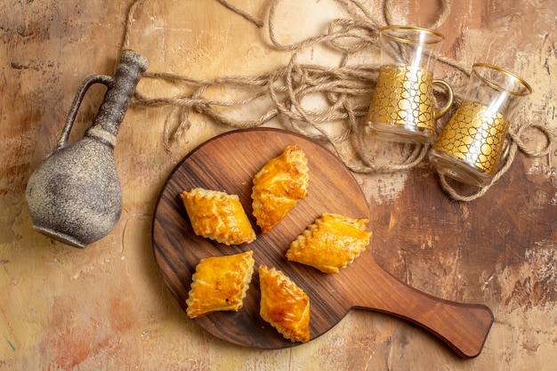 Free photo top view of delicious sweet pastries on wooden surface