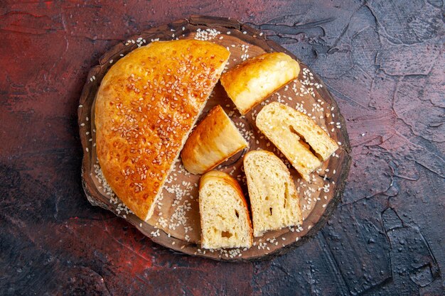 Top view delicious sweet pastry sliced in pieces on dark surface