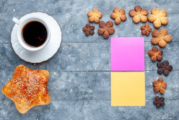 Top view of delicious sweet pastry star shaped with cookies coffee on grey desk, sweet bake pastry cake