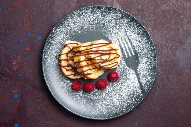 Top view delicious sweet rolls sliced sweets for tea inside plate on a dark background rolls biscuit dough sweet cake