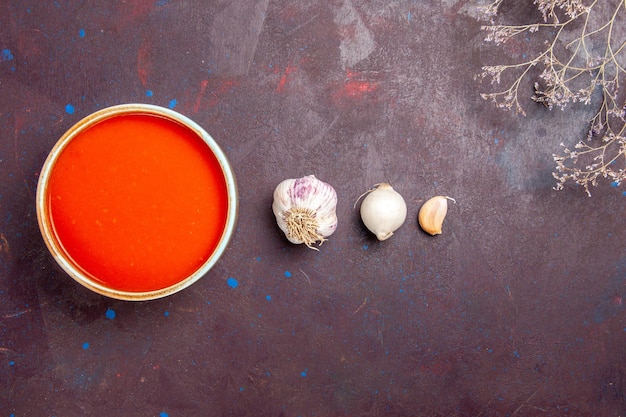 Delicious Tomato Soup Cooked from Fresh Tomatoes with Garlic on Dark Background