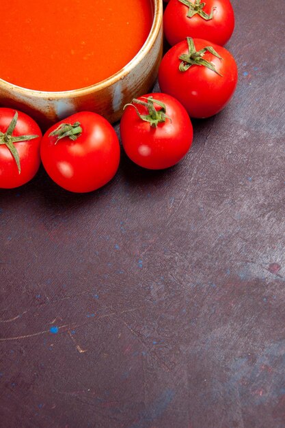 Top view delicious tomato soup with fresh red tomatoes on dark background tomato dish soup meal dinner