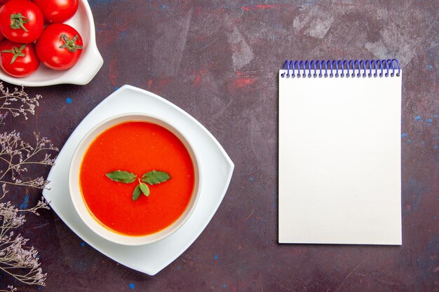 Top view delicious tomato soup with fresh tomatoes on a dark background dish sauce tomato color meal soup