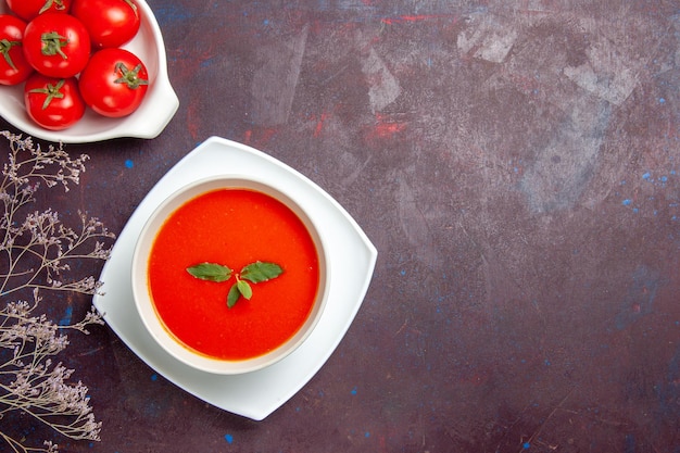 Top view delicious tomato soup with fresh tomatoes on dark background dish sauce tomato color meal soup