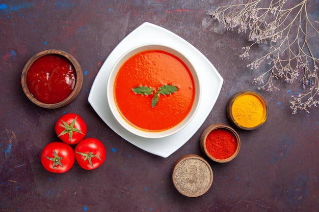 Top view delicious tomato soup with seasonings on dark background dish sauce tomato color meal soup