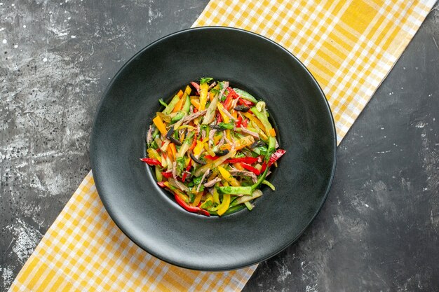 Top view delicious vegetable salad inside plate on grey background