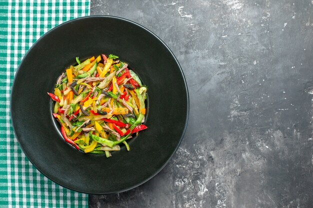 Top view delicious vegetable salad inside plate on grey background