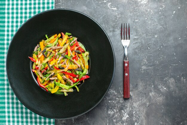 Top view delicious vegetable salad inside plate on grey background