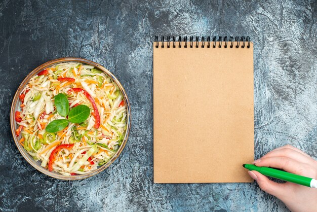 Top view delicious vegetable salad inside tray on grey background