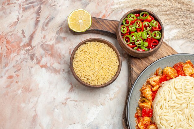 Top view of delicious white rice meal with chicken and vegetables