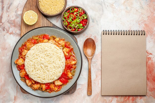 Top view of delicious white rice meal with chicken and vegetables