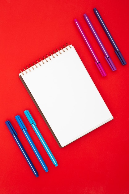 Top view desk arrangement with empty notepad