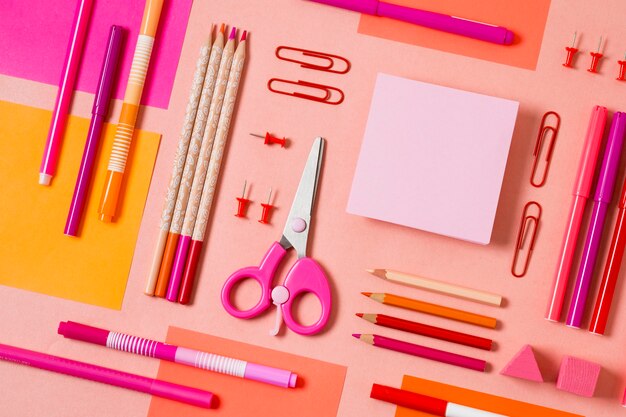 Top view desk arrangement with pink items