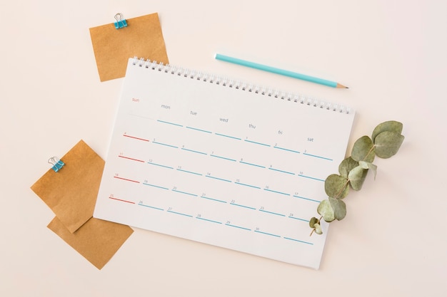 Top view desk calendar and leaves