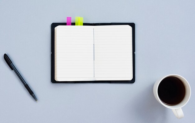 Top view desk concept with blank notepad 