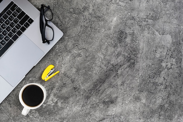 Top view desk concept with cement background