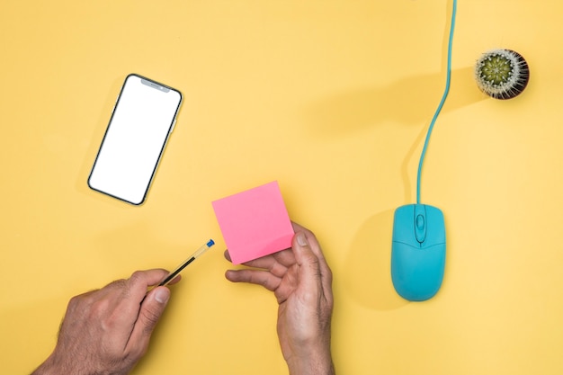 Top view desk concept with mockup smartphone