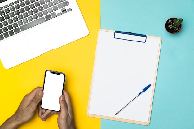 Top view desk concept with mockup smartphone