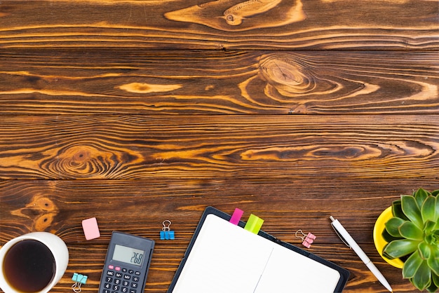 Top view desk concept with wooden background