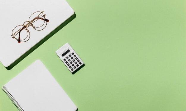 Top view desk minimal glasses and calculator