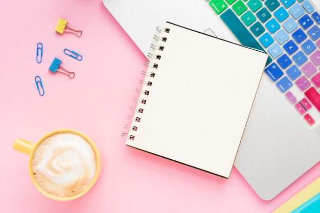 Top view of desk with blank notebook