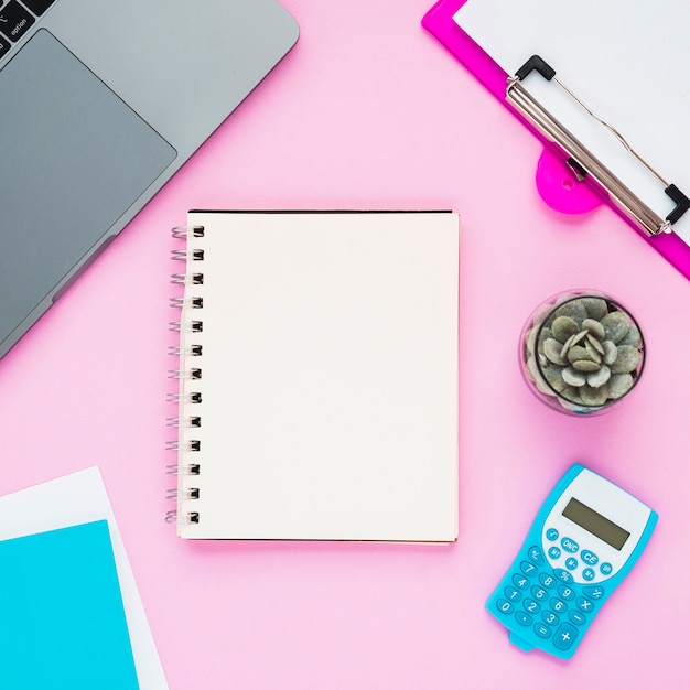 Top view of desk with blank notebook