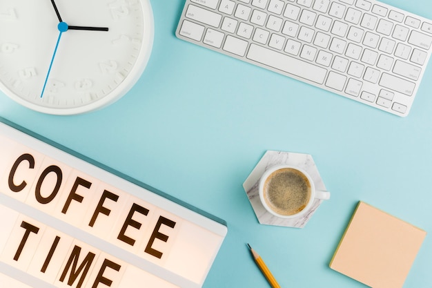 Top view of desk with keyboard and coffee