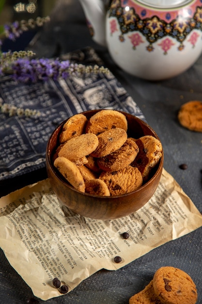 A top view desk with tea kettle and cookies