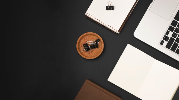 Top view of desktop with laptop and paper clips