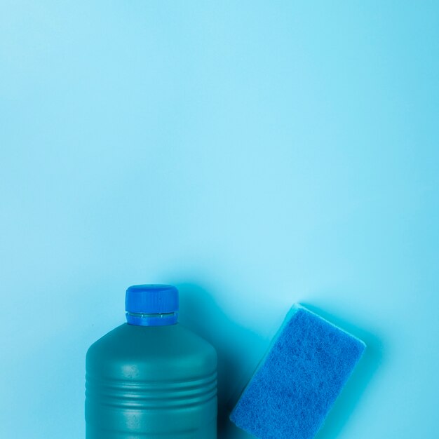 Top view detergent and sponge on blue background