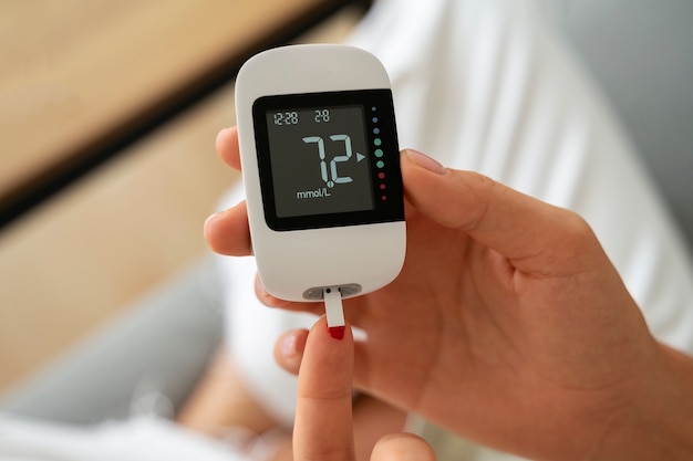 Top view diabetic woman checking her glucose level