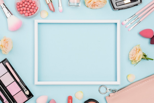 Top view different beauty products composition with empty frame