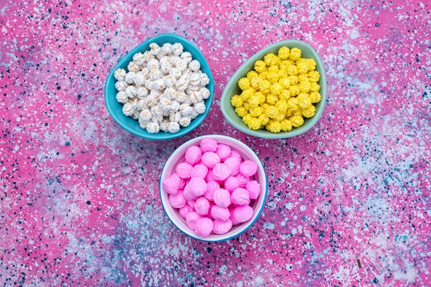 Top view different colored candies on the colorful background candy sugar goody photo