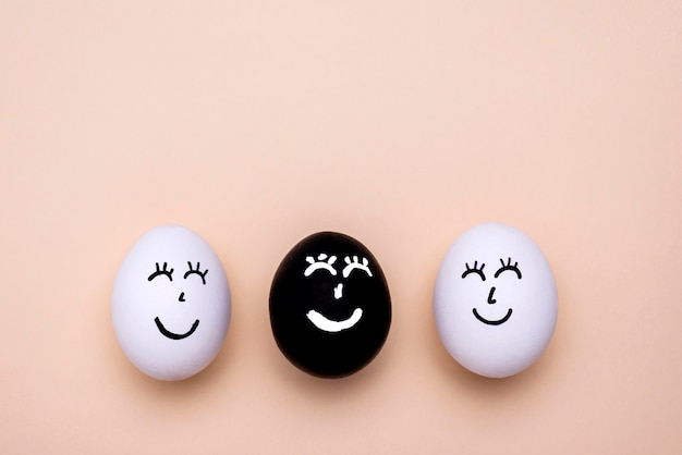 Top view of different colored eggs with faces for black lives matter movement