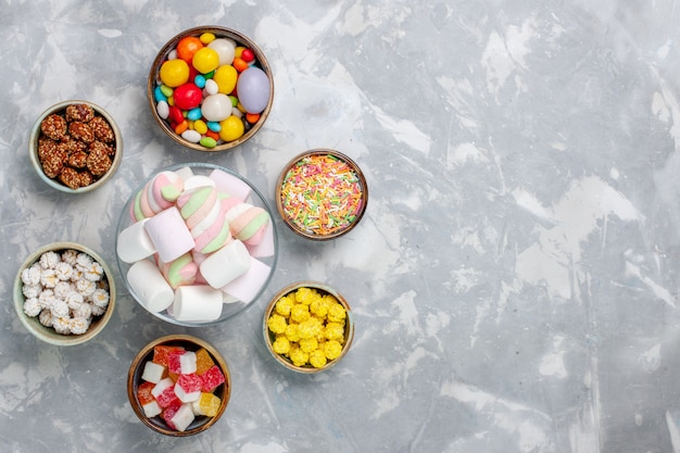 Top view different colorful candies with marmalade on the white desk