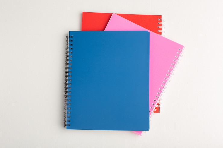 Free Photo top view different colorful copybooks on the white surface