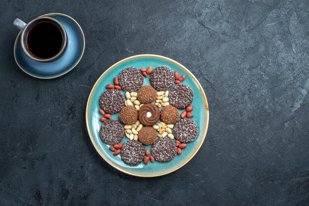 Top view different cookies chocolate based with nuts on the grey background candy bonbon sugar sweet cake cookie