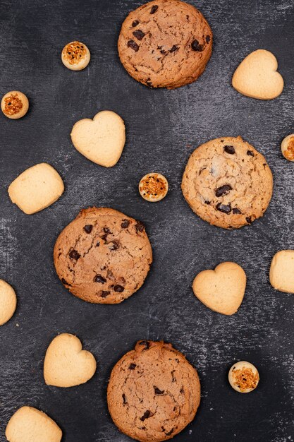 top view different cookies on dark surface