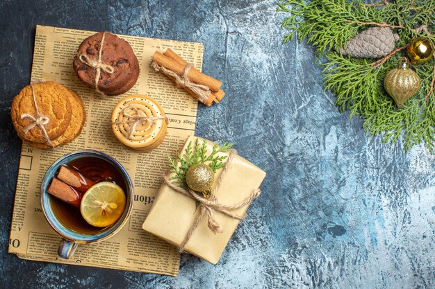 Top view different delicious biscuits with cup of tea on the light background