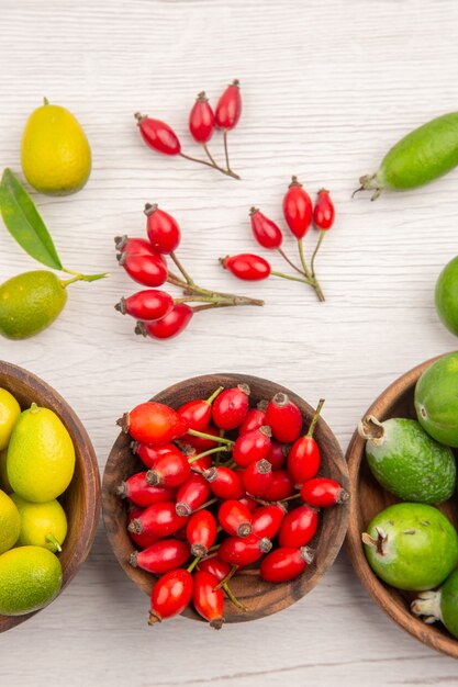 Top view different fresh fruits inside plates on white background exotic ripe color healthy life tropical