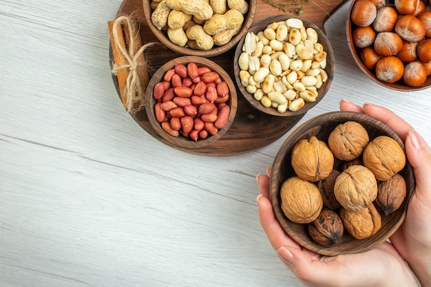 Top view different fresh nuts peanuts hazelnuts and walnuts