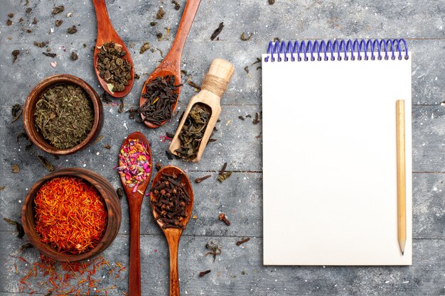 top view different fresh tea dried flavors on grey desk