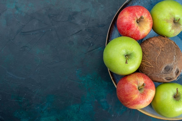 Top view different fruit composition coconut apples and bananas on dark blue desk