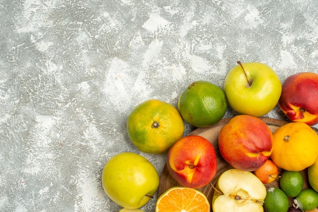 Top view different fruit composition sliced whole fresh fruits on a white background tree vitamine fresh color fruit ripe