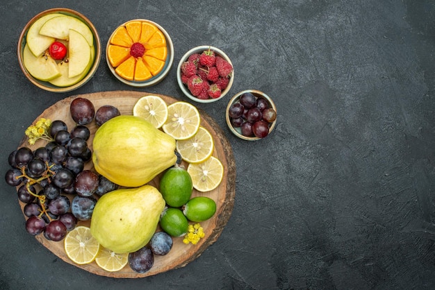 Vista dall'alto composizione di diversi frutti freschi e maturi su sfondo grigio scuro frutti morbidi salute maturi freschi